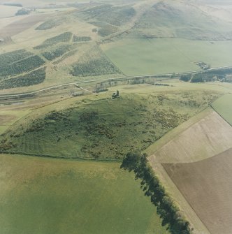 Oblique aerial view centred on the remains of the fort and rig, taken from the NE.