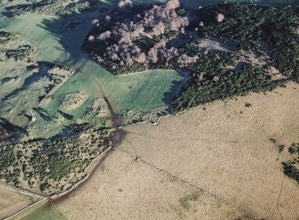 Oblique aerial view centred on the remains of the recumbent stone circle, taken from the WSW.