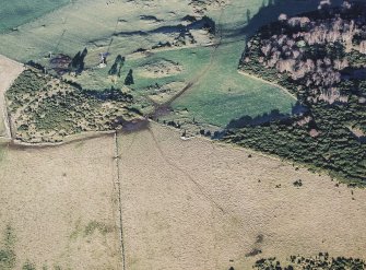 Oblique aerial view centred on the remains of the recumbent stone circle, taken from the SSW.