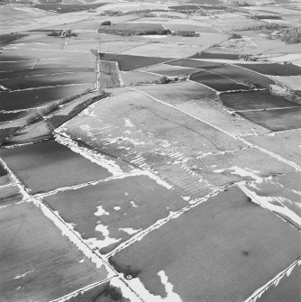 Oblique aerial view centred on the remains of the ring-cairn and rig, taken from the ESE.
