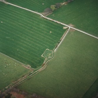 Oblique aerial view of the remains of the recumbent stone circle, taken from the SW.