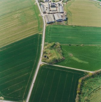 Oblique aerial view centred on the remains of the castle and tower-house, taken from the ENE.