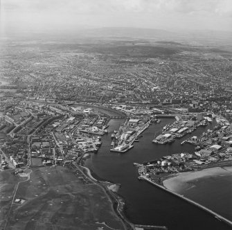 Oblique aerial view centred on the harbour, taken from the E.

