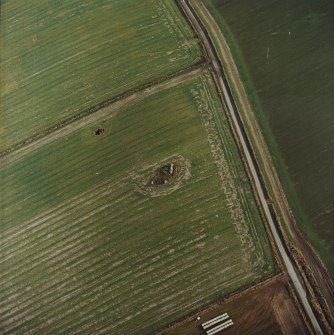 Oblique aerial view centred on the remains of the recumbent stone circle, taken from the W.