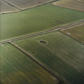 Oblique aerial view centred on the remains of the recumbent stone circle, taken from the NNE.