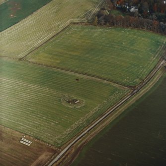 Oblique aerial view centred on the remains of the recumbent stone circle with the manse adjacent, taken from the SW.