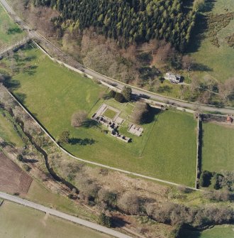 Oblique aerial view centred on the remains of the abbey and the house, taken from the SSE.