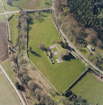Oblique aerial view centred on the remains of the abbey and the house, taken from the ESE.