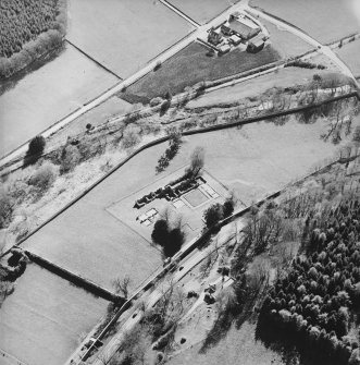 Oblique aerial view centred on the remains of the abbey and the house, farmhouse and farmsteading, taken from the NE.