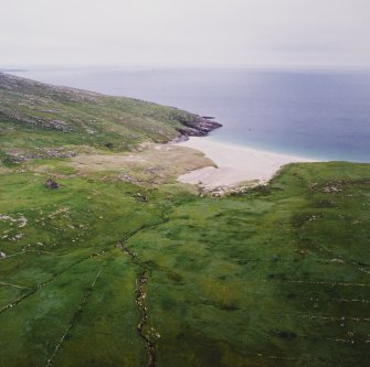 Oblique aerial view centred on the remains of the township with the remains of the chapel house adjacent, taken from the SW.