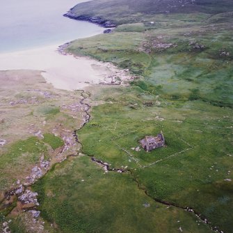 General oblique aerial view centred on the remains of the chapel house and enclosure with the remains of the township, chapel and graveyard and the school and schoolroom adjacent, taken from the N.