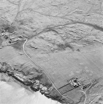 Oblique aerial view of Caoles and Crossapol centred on a farmstead and sheepfold, a house and the remains of two farmsteads and a burial ground, taken from the ENE.