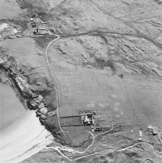 Oblique aerial view of Caoles and Crossapol centred on a farmstead and sheepfold, a house and the remains of two farmsteads and a burial ground, taken from the NE.
