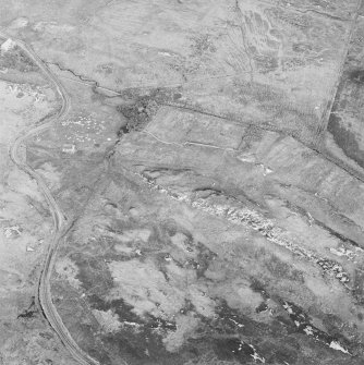 Oblique aerial view of Dun an Achaidh centred on the remains of a dun, taken from the W.