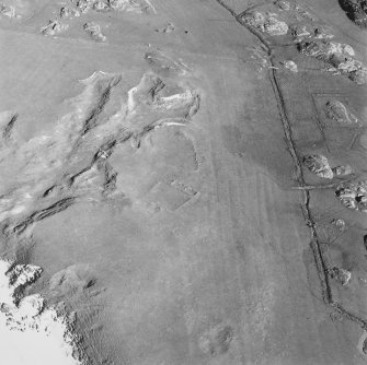 Oblique aerial view ofTraigh Na Criche, taken from the north west, centred on farmstead and cultivation remains.