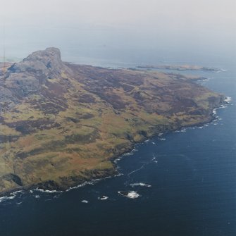 General oblique aerial view centred on the remains of the township, field-system, rig and lazy-beds with An Sgurr fort adjacent, taken from the WSW.
