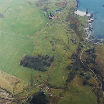 Oblique aerial view centred on the remains of the church with farmhouse, barn and farmsteading adjacent, taken from the NW.