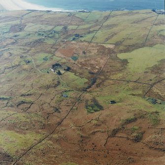 Oblique aerial view of the crofting township and field-system with farmstead adjacent taken from the NE.