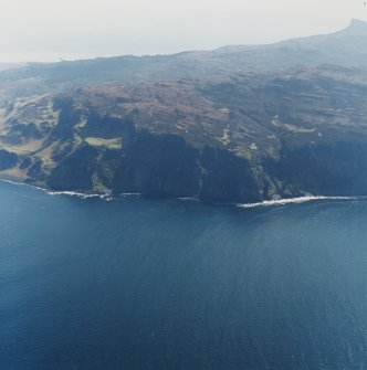 General oblique aerial view of the west side of Eigg with the fort in the foreground and the Sgurr fort beyond, taken from the NW.