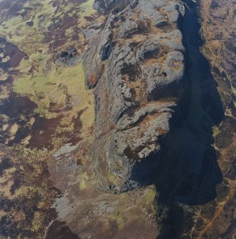 Oblique aerial view centred on the E end of An Sgurr and the remains of the fort, taken from the E.