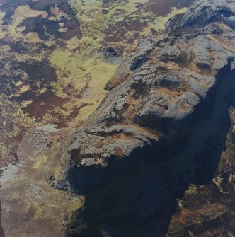 Oblique aerial view centred on the E end of An Sgurr and the remains of the fort, taken from the NE.