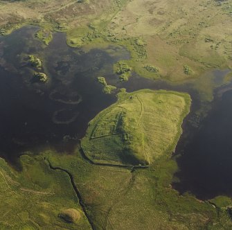 Oblique aerial view of Eilean A Bharain, taken from the east, centred on a farmstead.