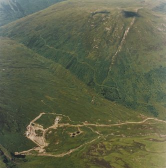 Oblique aerial view centred on the mine and buildings, taken from the S.