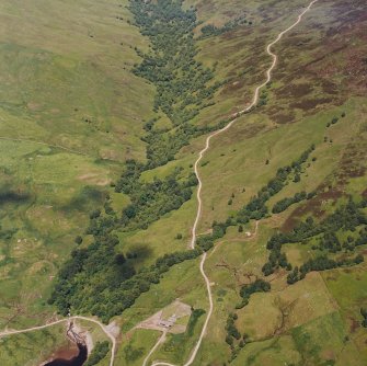 Oblique aerial view centred on the remains of field-systems, rig, head-dyke and shieling-huts, taken from the SW.