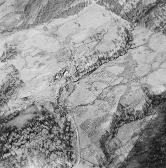 Oblique aerial view of Anie centred on a farmstead, the remains of a field-system, rig and a military road, taken from the SSW.