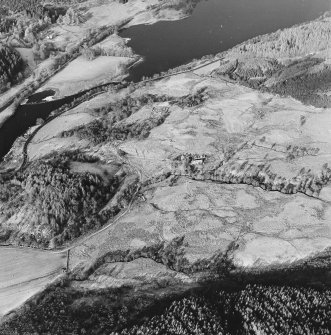 Oblique aerial view of Anie centred on a farmstead, the remains of a field-system, rig and a military road, taken from the SE.