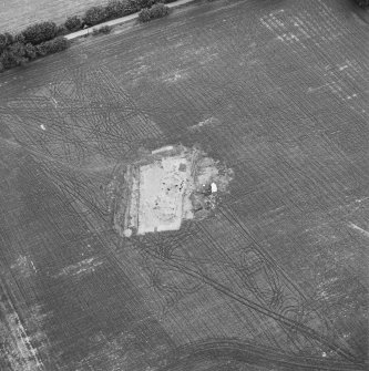 Oblique aerial view centred on the excavation of the timber hall, taken from the S.