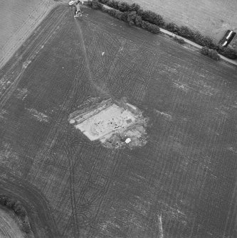 Oblique aerial view centred on the excavation of the timber hall, taken from the SE.