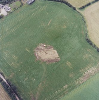 Oblique aerial view centred on the excavation of the timber hall, taken from the NW.