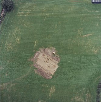 Oblique aerial view centred on the excavation of the timber hall, taken from the SW.