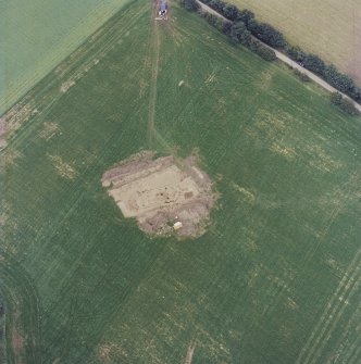 Oblique aerial view centred on the excavation of the timber hall, taken from the SE.