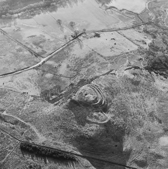 Oblique aerial view of Dunmore centred on the remains of a fort and well, taken from the N.