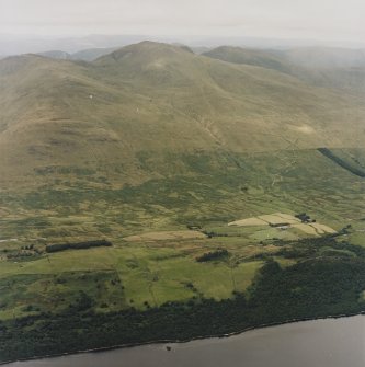 General oblique aerial view looking across the farmstead of Carie towards Ben Lawers, taken from the SSE.