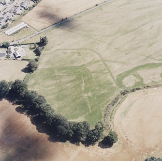 Dalginross, oblique aerial view, taken from the NW, centred on the cropmarks of the Roman Fort. The Roman Temporary camp is visible in the top half of the photograph.