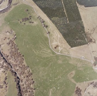 Aerial view of buildings, huts and enclosures to the NW of Newtonmore, taken from the SSW.