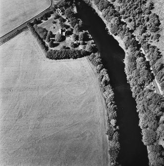 Comrie Castle, oblique aerial view, taken from the SE, centred on cropmarks including those of an enclosure. Comrie Castle is visible in the top centre of the photograph.