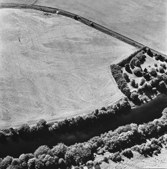 Comrie Castle, oblique aerial view, taken from the NE, centred on cropmarks including those of an enclosure. Comrie Castle is visible in the centre right of the photograph.