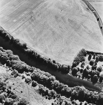 Comrie Castle, oblique aerial view, taken from the N, centred on cropmarks including those of an enclosure. Comrie Castle is visible in the centre right of the photograph.