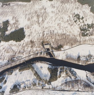 Oblique aerial view of the electricity generating power station, lodge, electricity transformer station and the remains of the possible barrow, taken from the SSW.