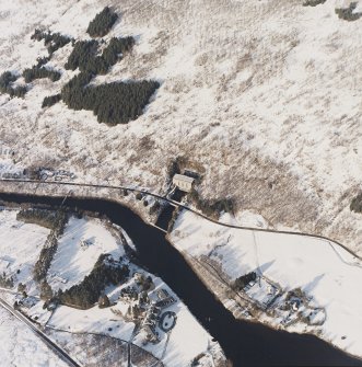 Oblique aerial view of the electricity generating power station and lodge with the remains of the possible barrow adjacent, taken from the S.