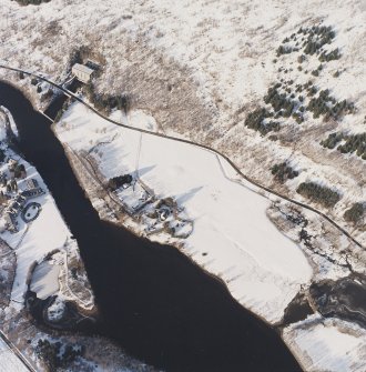 Oblique aerial view centred on the possible barrow with the electricity generating station adjacent, taken from the SSE.