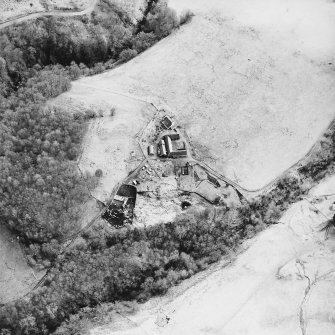 Oblique aerial view centred on the farmstead and the remains of the township, taken from the NW.