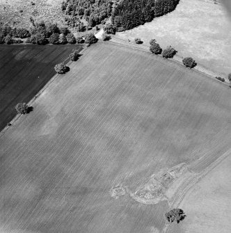 Oblique aerial view centred on the cropmarks of the quarry pits and remains of the water tank, taken from the SE.