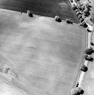 Oblique aerial view centred on the cropmarks of Roman quarry pits, taken from the ENE.