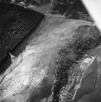 Oblique aerial view centred on the remains of buildings, field system, rig and trackways, taken from the SE.