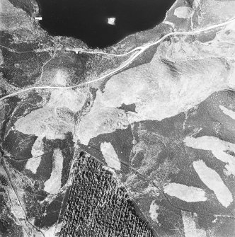 Oblique aerial view centred on the remains of possible shieling-huts, trackway and possible hut-circle with possible artificial island adjacent, taken from the SW.